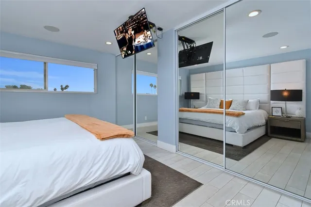 a bedroom with a bed and a television