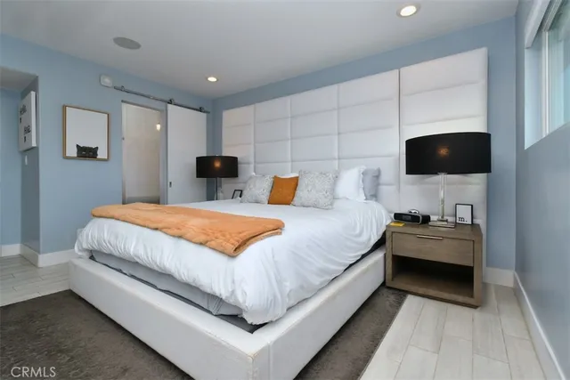 a bedroom with furniture and a flat screen tv