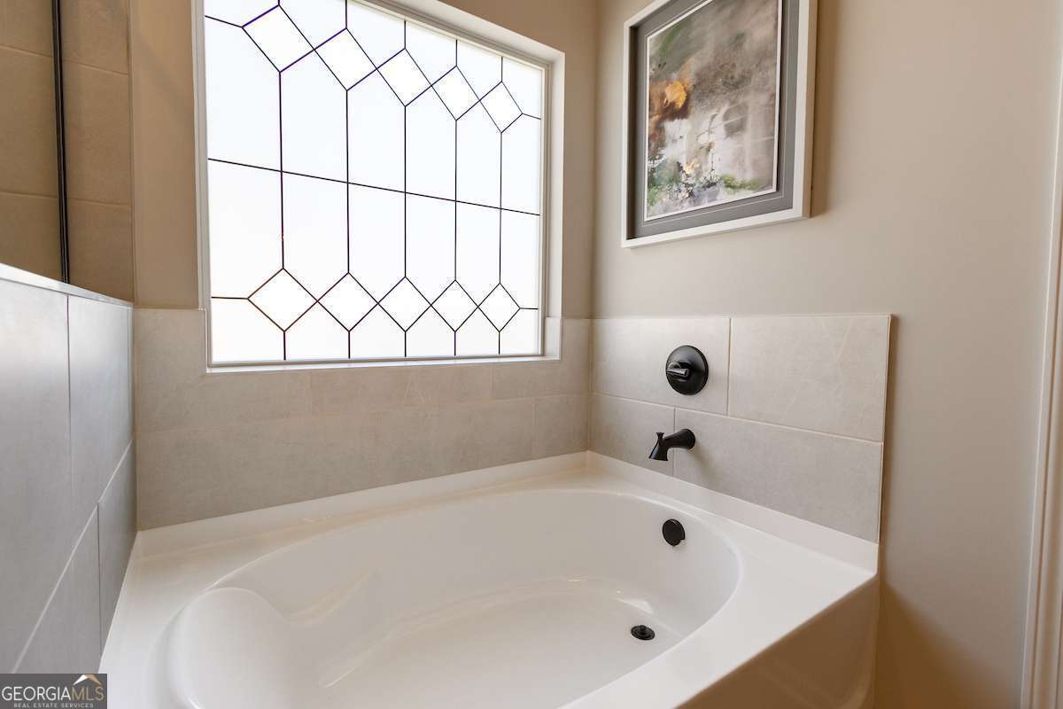242 Shantz Way Byron, GA 31008 - Photo 27 of 34 a white bath tub sitting next to a window