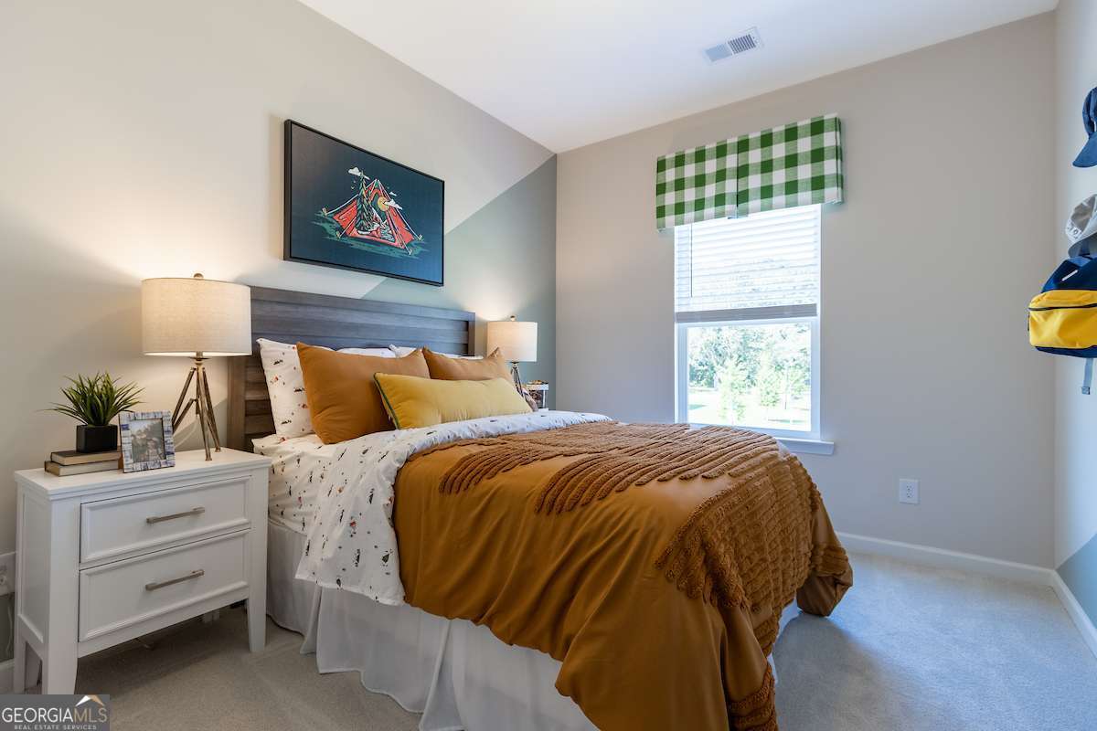 242 Shantz Way Byron, GA 31008 - Photo 29 of 34 a bed sitting in a bedroom next to a window