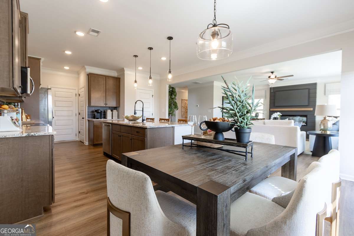 242 Shantz Way Byron, GA 31008 - Photo 6 of 34 a large kitchen with granite countertop a stove and white cabinets