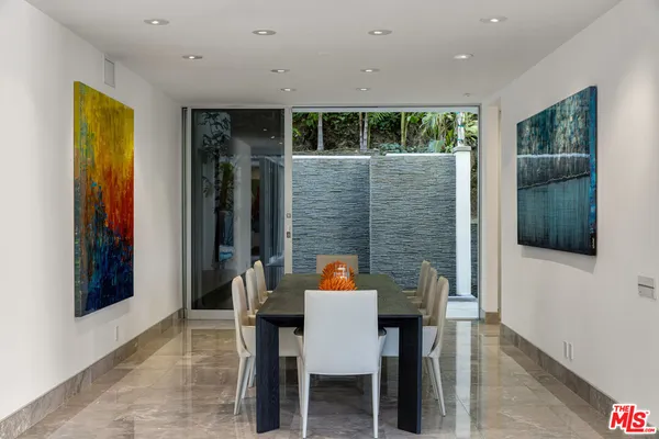 a outdoor dining space with furniture and window