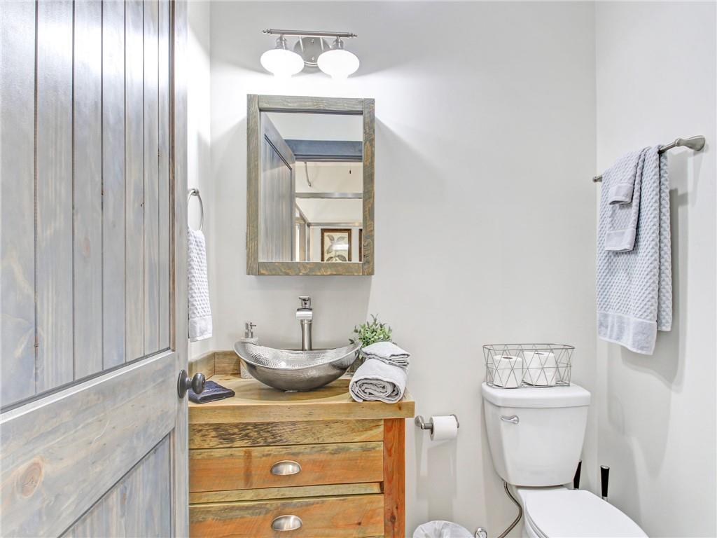 685 East Main Street, Unit B Blue Ridge, GA 30513 - Photo 24 of 57 a bathroom with a toilet a sink and mirror