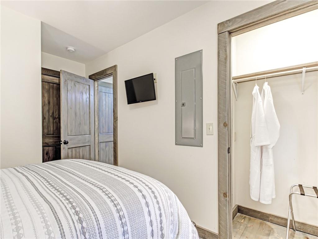 685 East Main Street, Unit B Blue Ridge, GA 30513 - Photo 28 of 57 a bedroom with a bed and a flat tv screen