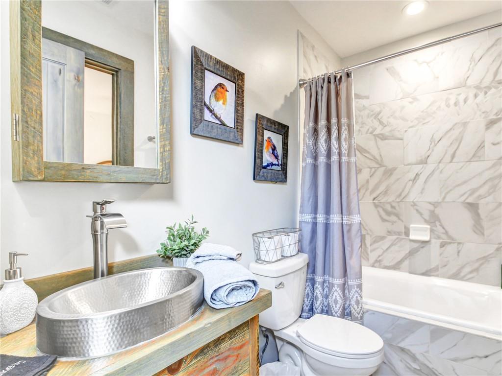 685 East Main Street, Unit B Blue Ridge, GA 30513 - Photo 29 of 57 a bathroom with a granite countertop sink and a bathtub