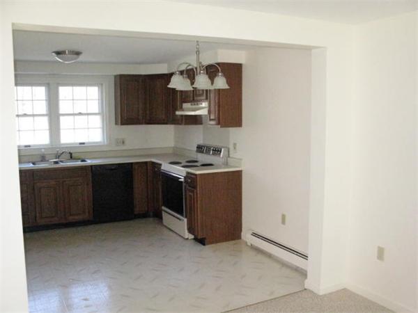 20 1/2 Webb Street, Unit 2A Middleton, MA 01949 - Photo 2 of 17 a kitchen with stainless steel appliances granite countertop a sink stove and cabinets