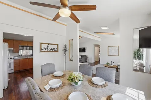 a dining room with furniture and wooden floor