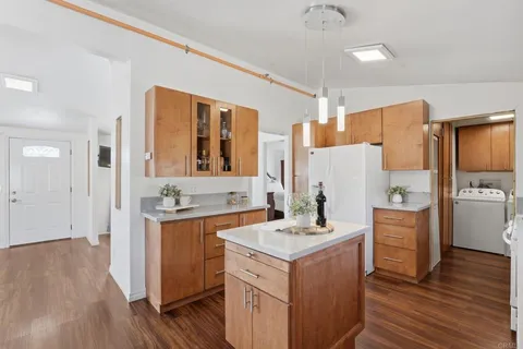 a kitchen with a sink stove and refrigerator