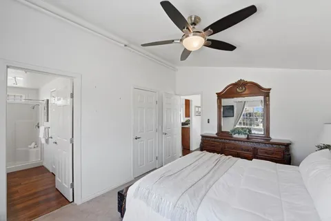 a bedroom with a bed and a chandelier