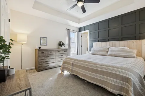 a bedroom with a bed and a table