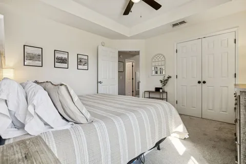 a spacious bedroom with a bed and a chandelier