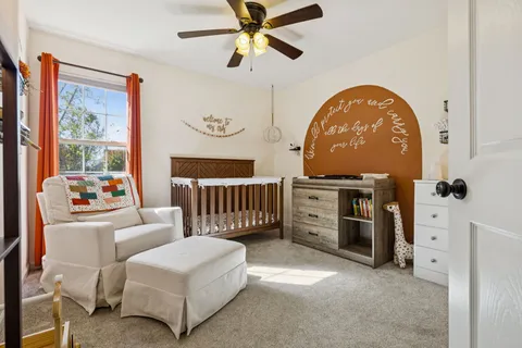 a living room with furniture and a ceiling fan