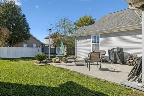 a view of a house with backyard porch and sitting area