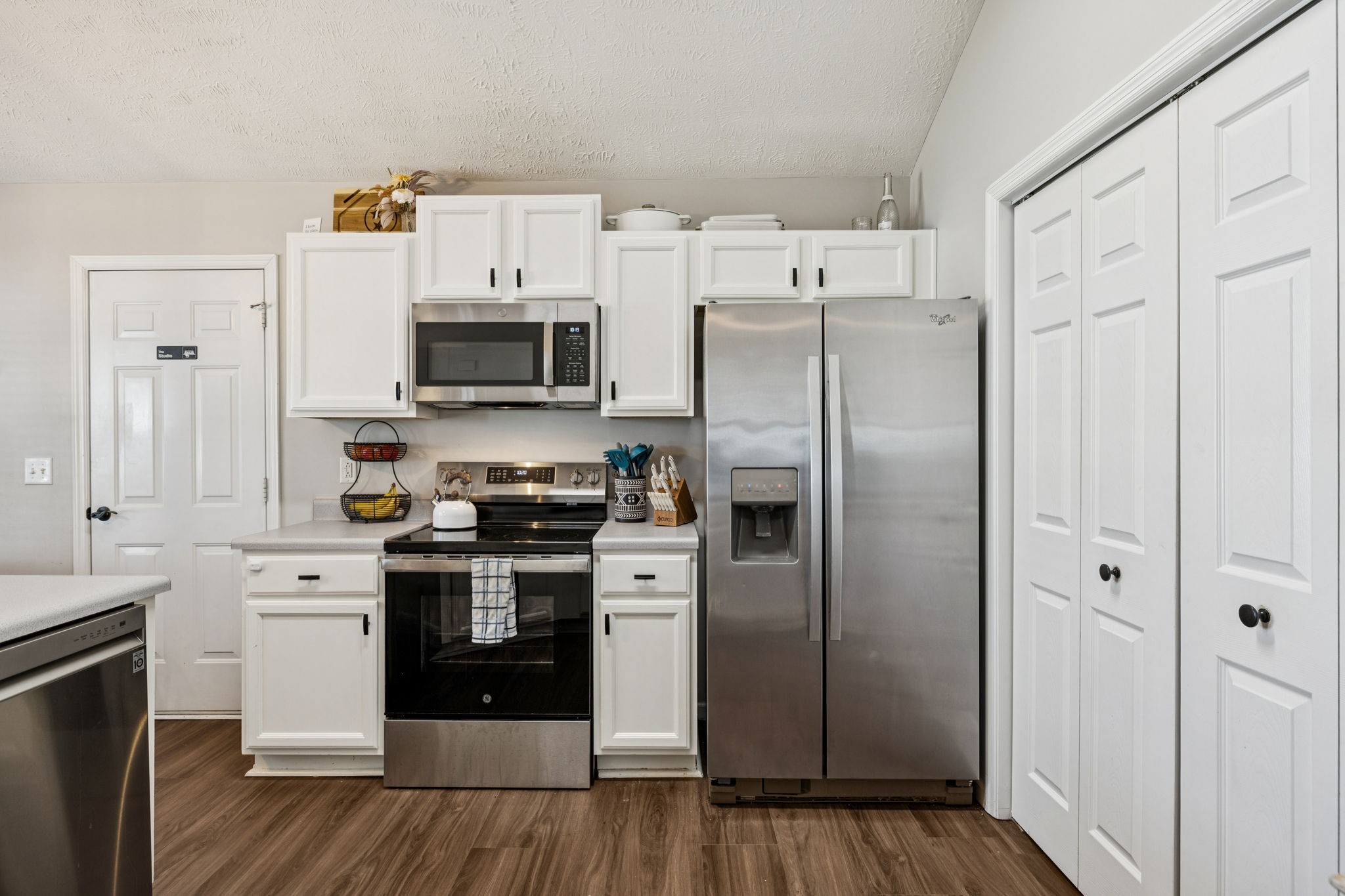 5049 Tabitha Street Murfreesboro, TN 37129 - Photo 9 of 28 a kitchen with stainless steel appliances a stove a refrigerator and white cabinets