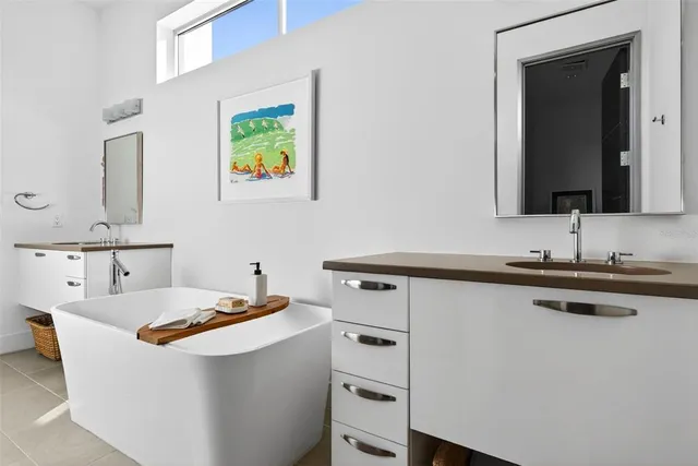 a room with a sink and a painting on the wall