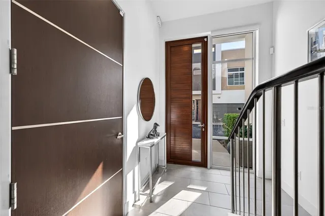 a view of a hallway with wooden floor and entryway