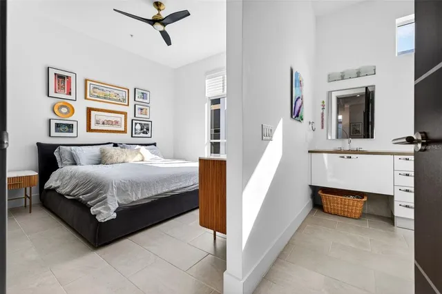 a spacious bedroom with a bed and a flat screen tv