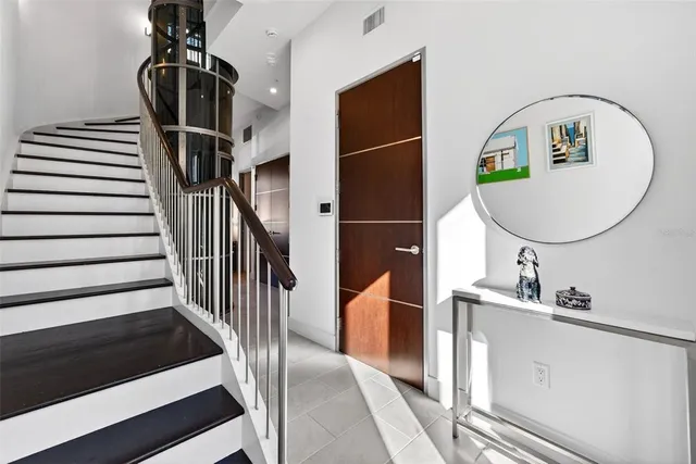 a view of entryway and hall with wooden floor