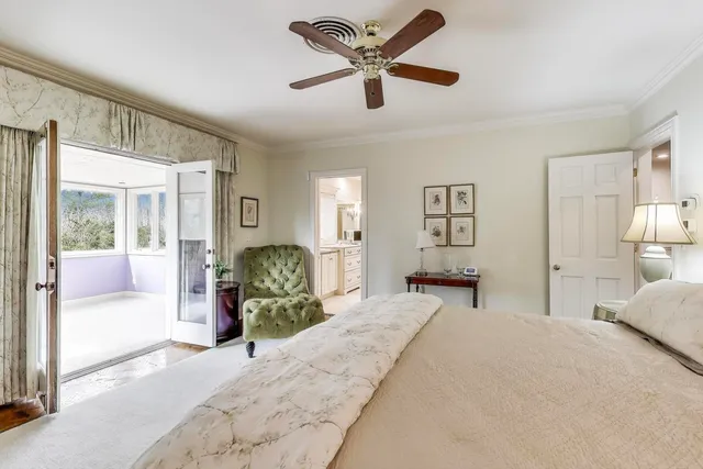 a bedroom with a bed and painting on the wall