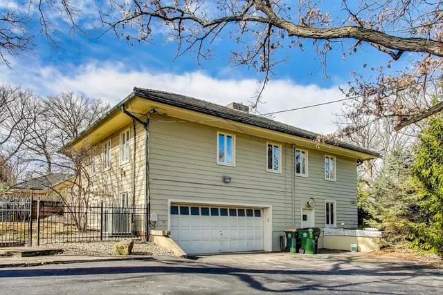 a front view of a house with yard patio and outdoor seating