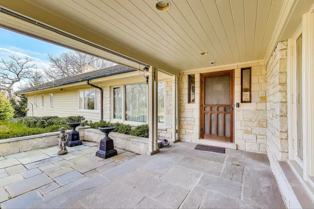 a view of a porch with furniture and floor to ceiling window