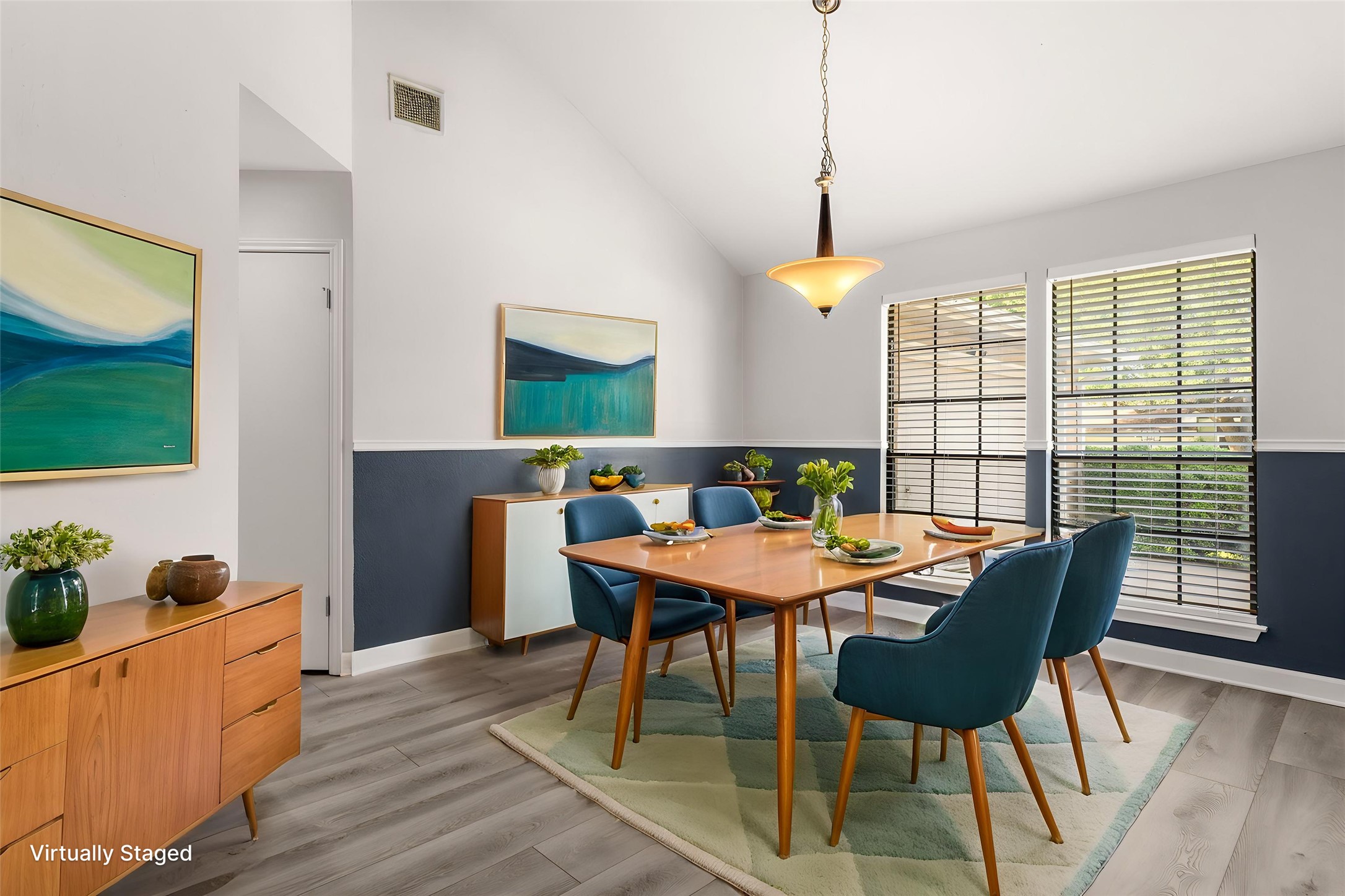 2409 Water Well Lane Austin, TX 78728 - Photo 5 of 22 Dining area featuring vaulted ceilings, wood-finish flooring, and a contemporary pendant light fixture