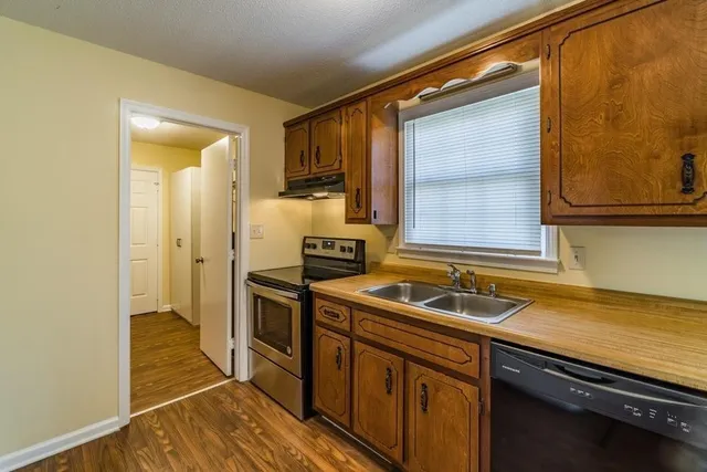 a kitchen that has a sink and a stove