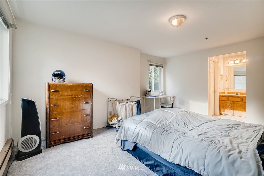 19410 Bothell Way Northeast, Unit D204 Bothell, WA 98011 - Photo 14 of 26 a bedroom with a bed and a large window