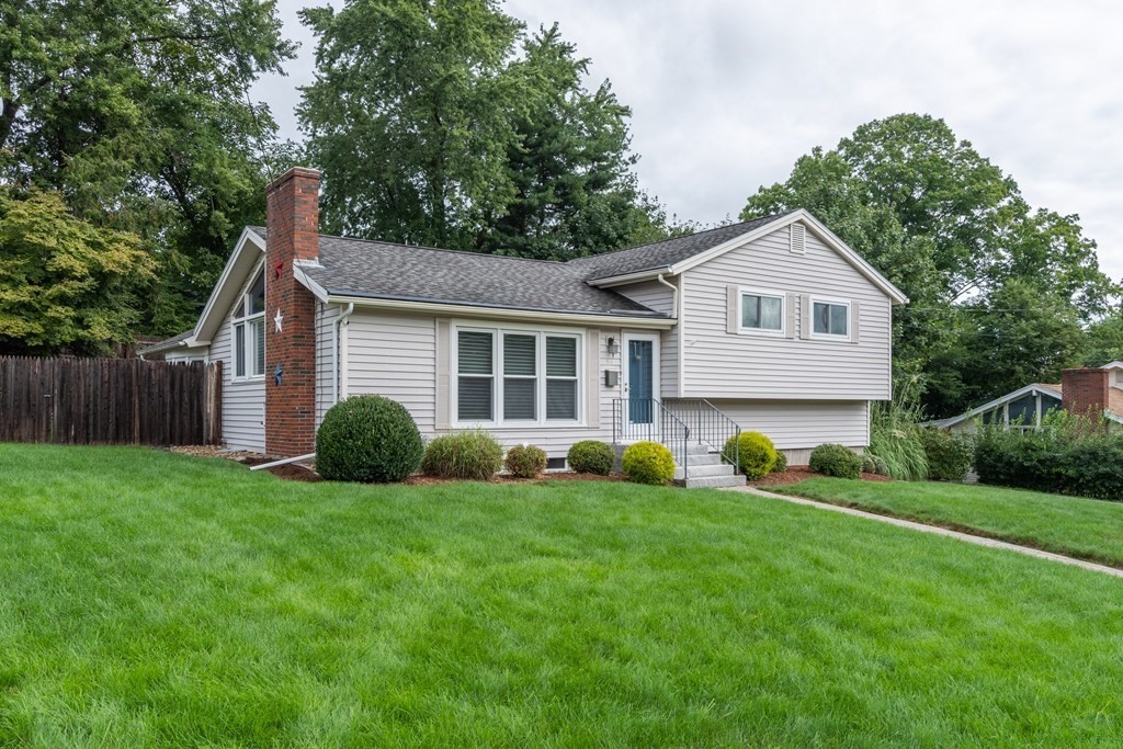 64 Hills Ferry Road Nashua, NH 03064 - Photo 1 of 34 a view of a house with a yard and sitting area