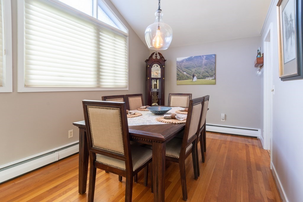 64 Hills Ferry Road Nashua, NH 03064 - Photo 13 of 34 a view of a dining room with furniture wooden floor and chandelier