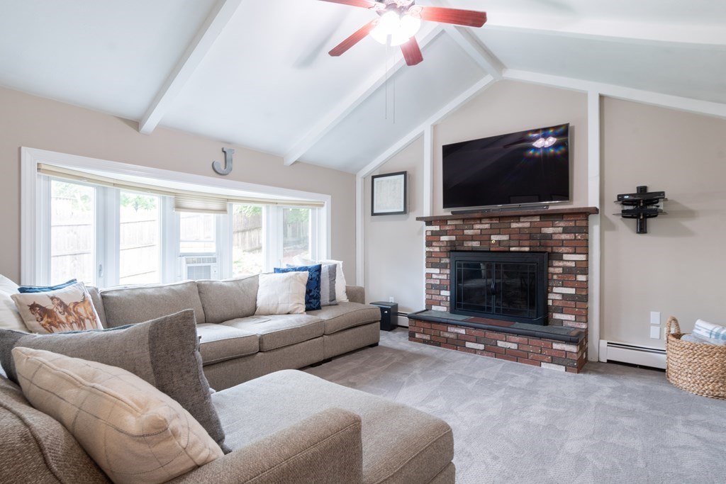 64 Hills Ferry Road Nashua, NH 03064 - Photo 16 of 34 a living room with furniture a flat screen tv and a fireplace
