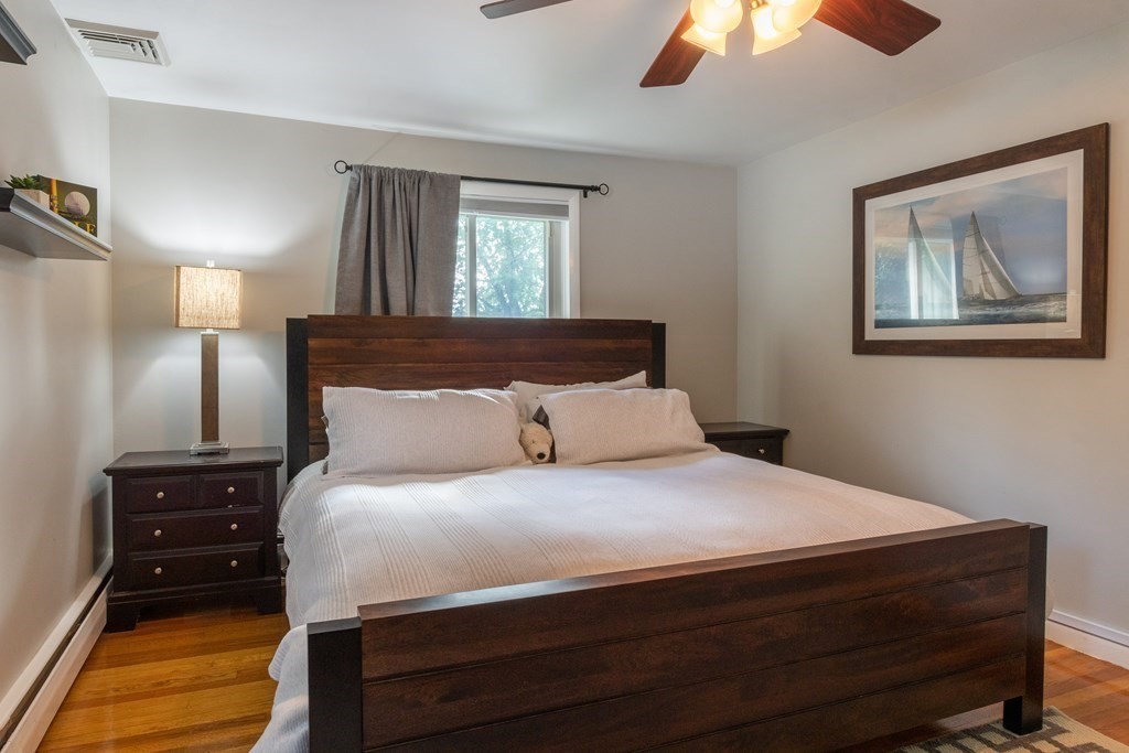64 Hills Ferry Road Nashua, NH 03064 - Photo 18 of 34 a bedroom with a bed and a painting