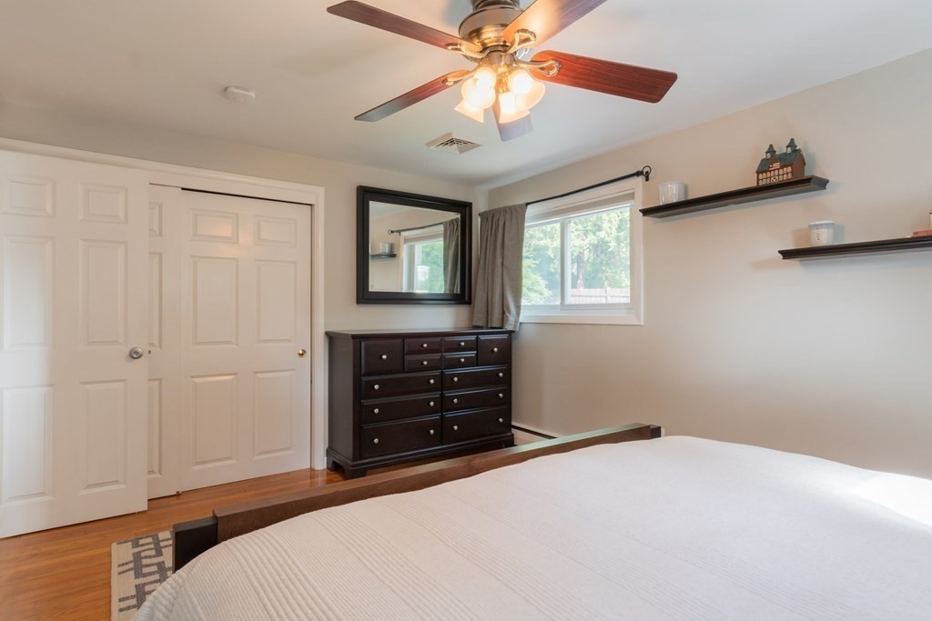 64 Hills Ferry Road Nashua, NH 03064 - Photo 19 of 34 a bedroom with a bed and a chandelier