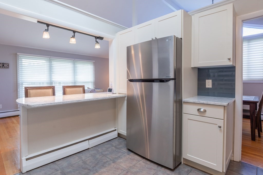 64 Hills Ferry Road Nashua, NH 03064 - Photo 9 of 34 a kitchen with stainless steel appliances a refrigerator and a more cabinets