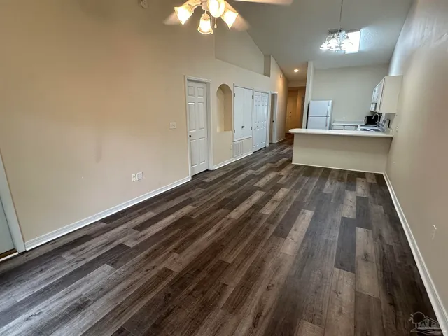 a view of a room with wooden floor