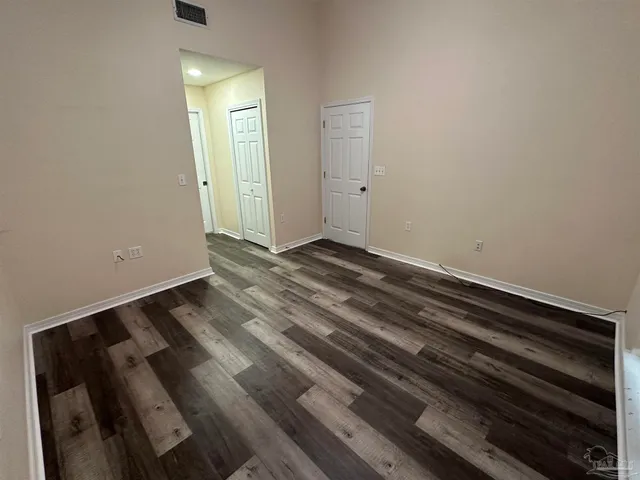 a view of a room with wooden floor