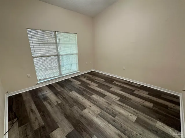 a view of wooden floor and cabinet in a room