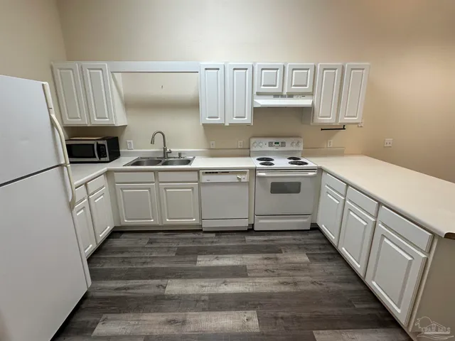 a kitchen with cabinets a sink and appliances