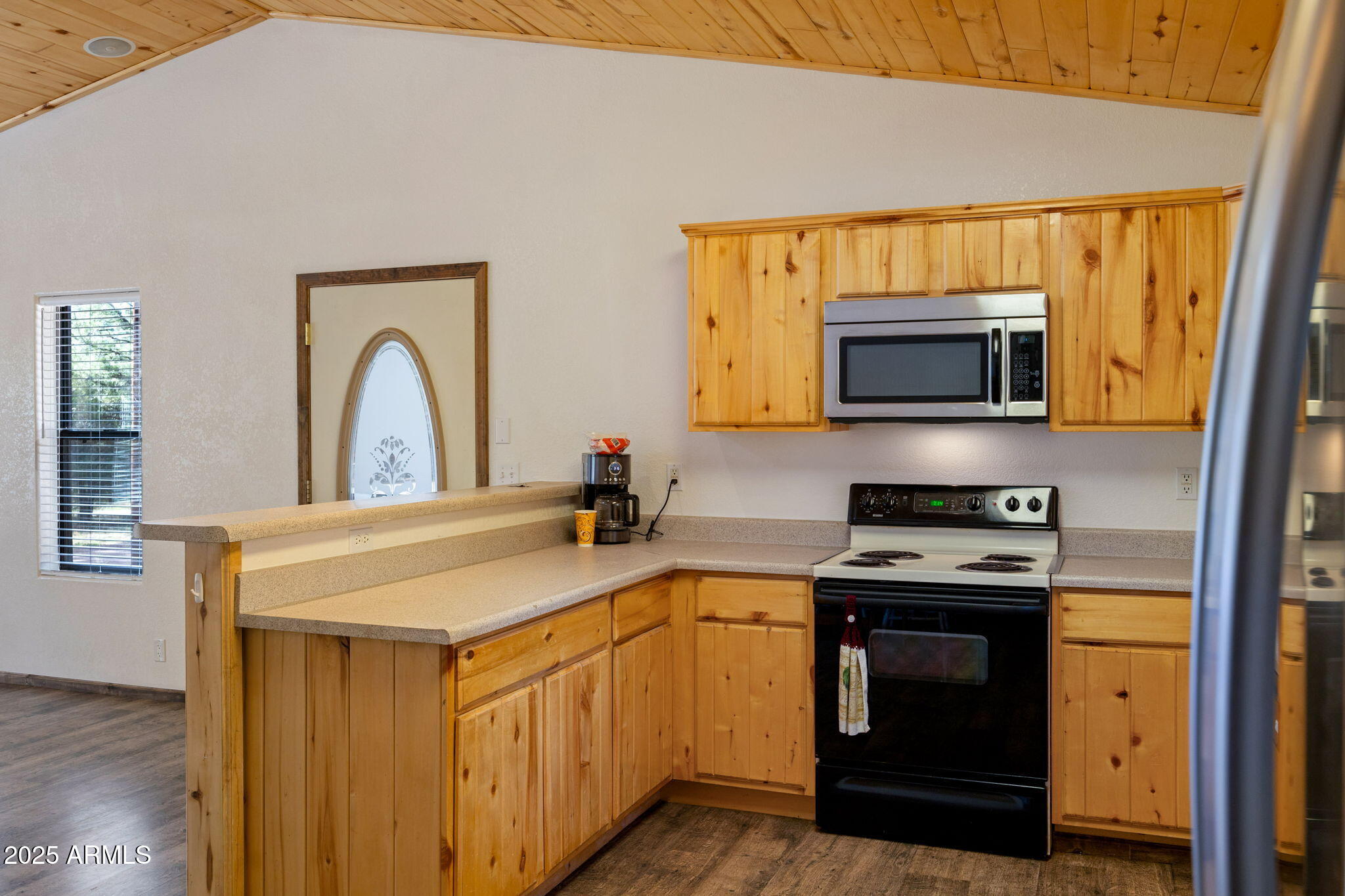 2882 Verde Road Overgaard, AZ 85933 - Photo 13 of 33 a kitchen with stainless steel appliances a stove microwave and a sink