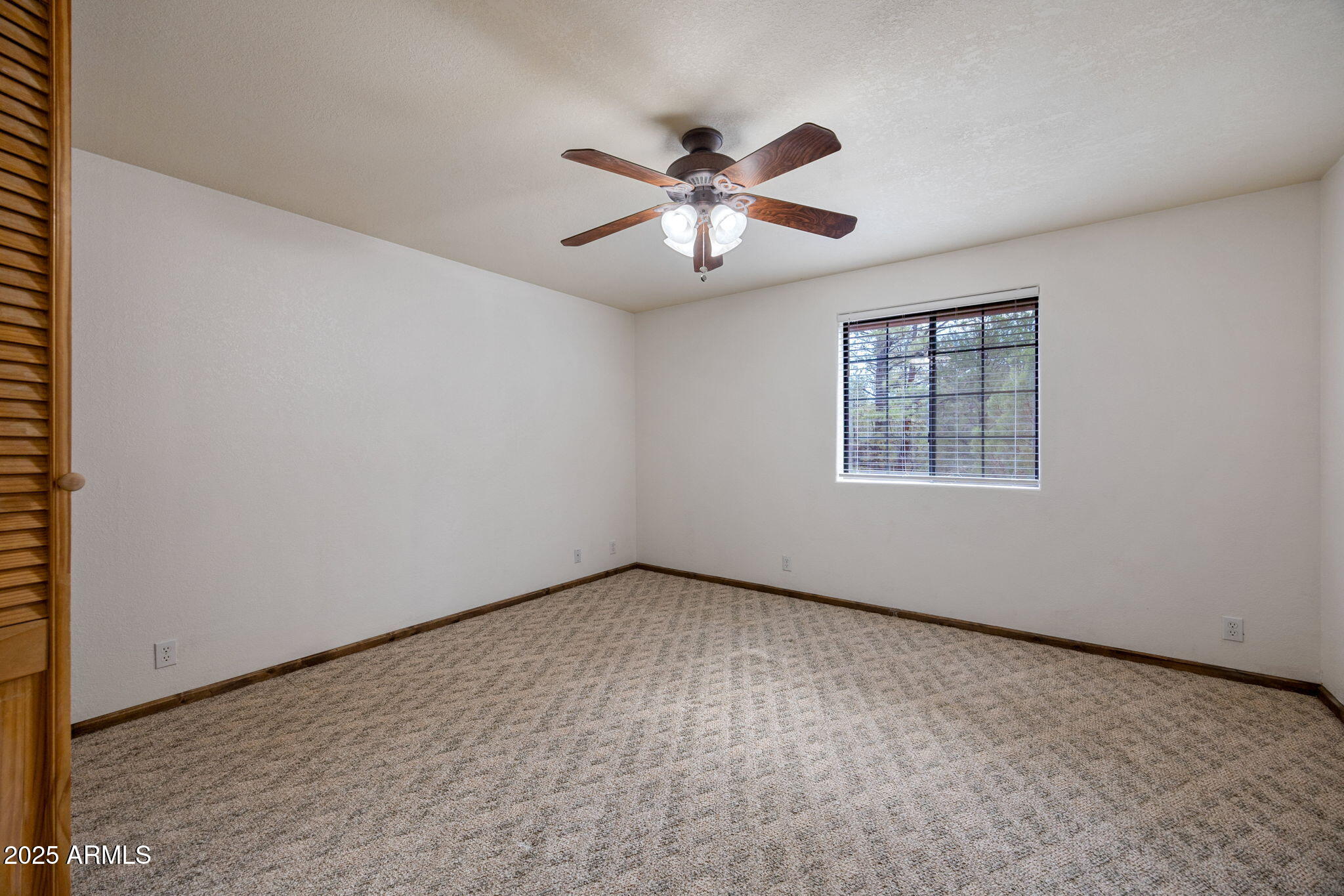 2882 Verde Road Overgaard, AZ 85933 - Photo 15 of 33 an empty room with windows and fan