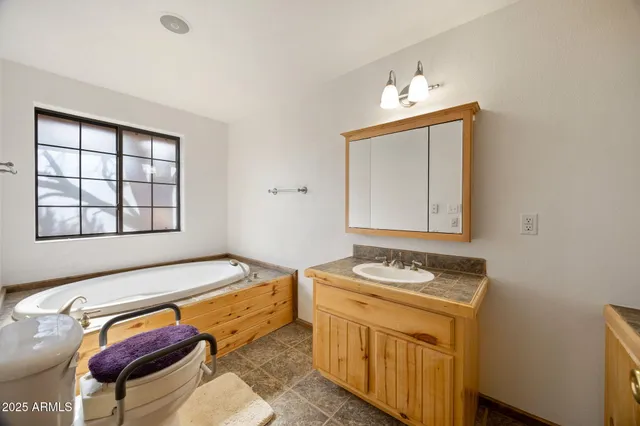 a view of an empty room and chandelier fan