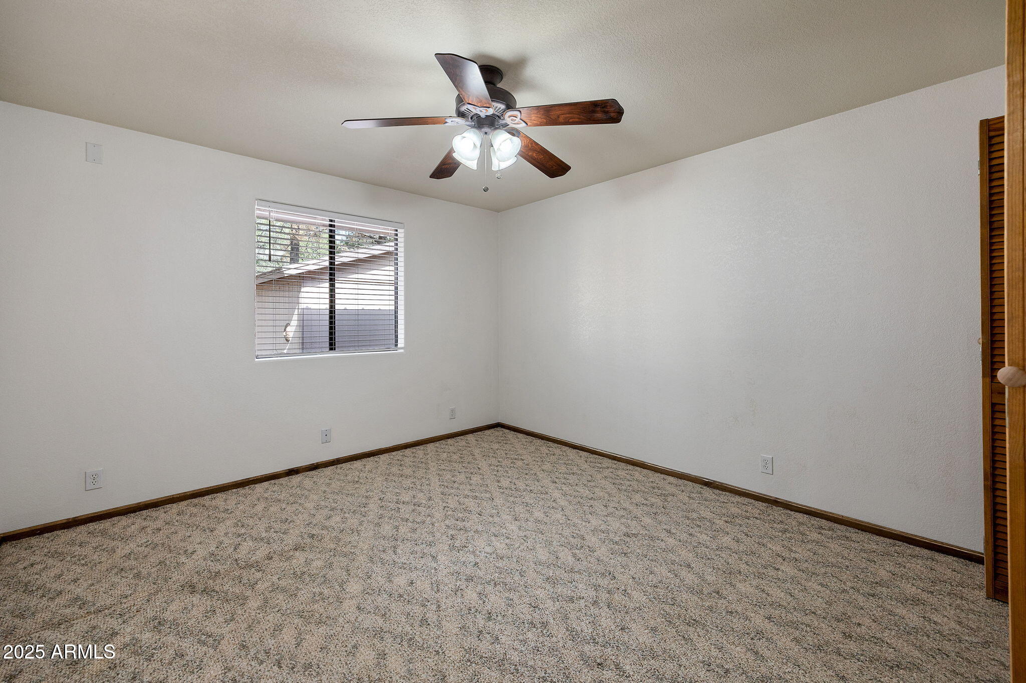 2882 Verde Road Overgaard, AZ 85933 - Photo 19 of 33 an empty room with windows and ceiling fan
