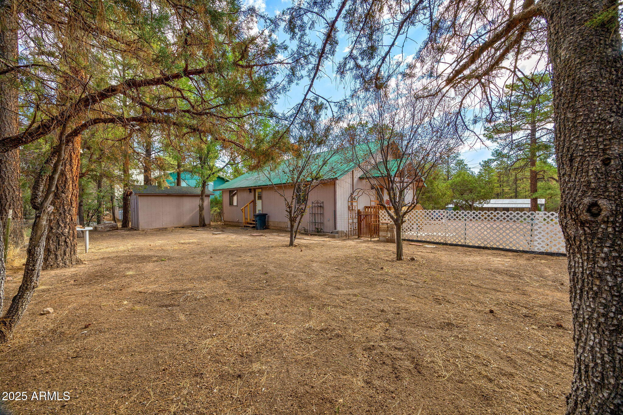 2882 Verde Road Overgaard, AZ 85933 - Photo 22 of 33 a house with trees in front of it