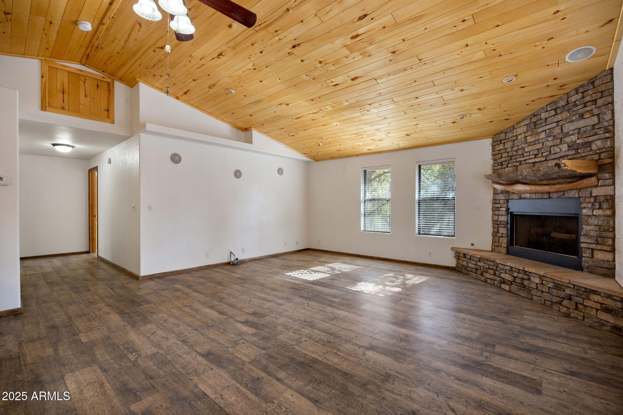 2882 Verde Road Overgaard, AZ 85933 - Photo 7 of 33 a view of an empty room with a fireplace and a window