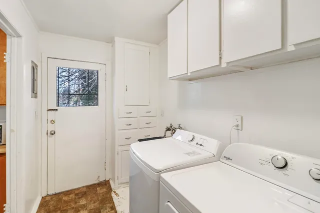 a view of a room with wooden floor and white wall
