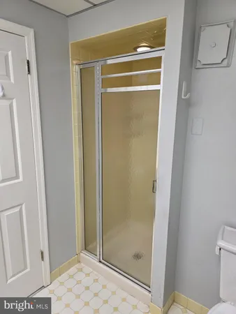 a bathroom with a glass shower door