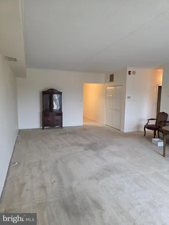 a view of empty room with a fireplace