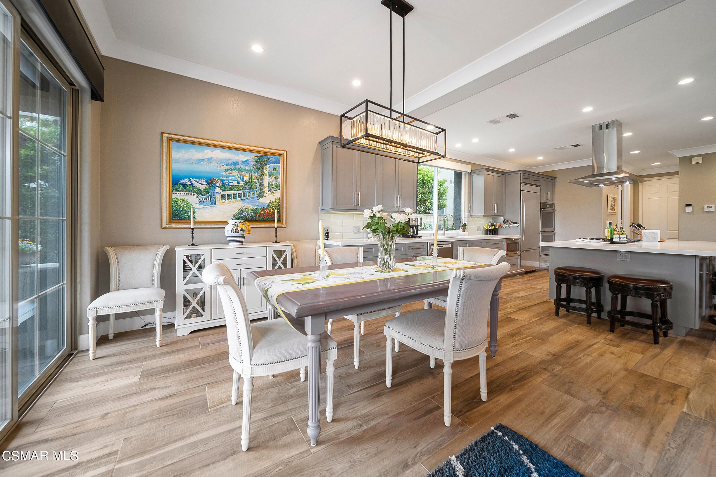 4150 Via Mira Monte Calabasas, CA 91301 - Photo 6 of 41 a dining area with a table chairs and a kitchen view