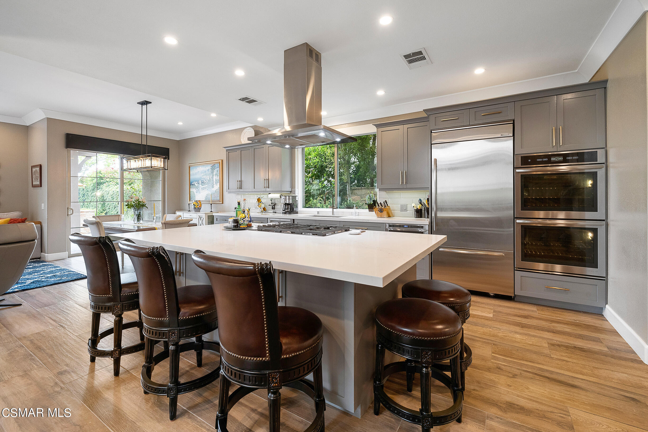 4150 Via Mira Monte Calabasas, CA 91301 - Photo 7 of 41 a kitchen with kitchen island a dining table and chairs
