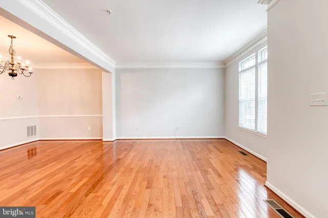 a kitchen with granite countertop a refrigerator a sink a stove a counter space and cabinets